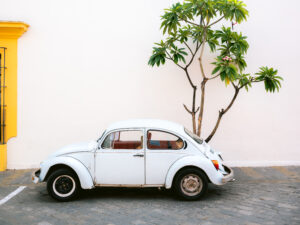 Pastel Volskwagen Beetle in the streets of Oaxaca Mexico by Raisa Zwart